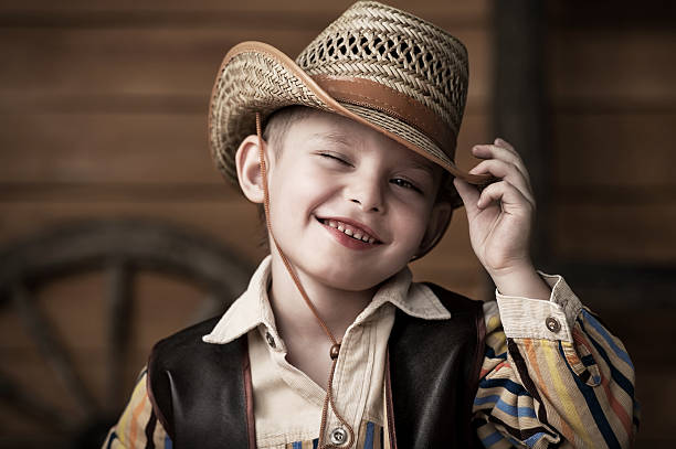 istock A little boy wearing a cowboy hat and outfit smiling 158768132