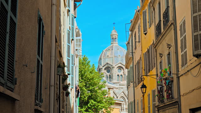 Narrow streets of the old town Marseille with the view of Basilica.