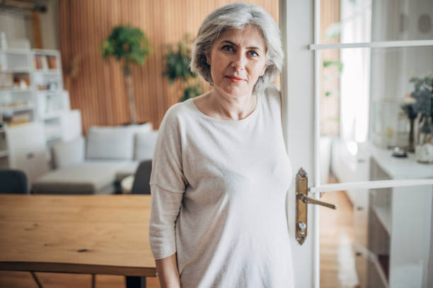istock Mature woman at home 1587695077