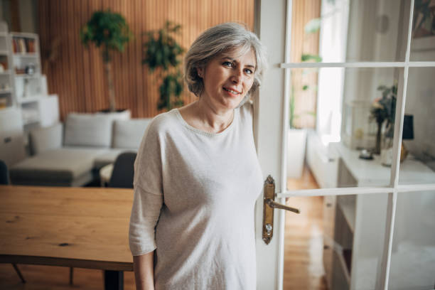 istock Mature woman at home 1587695087