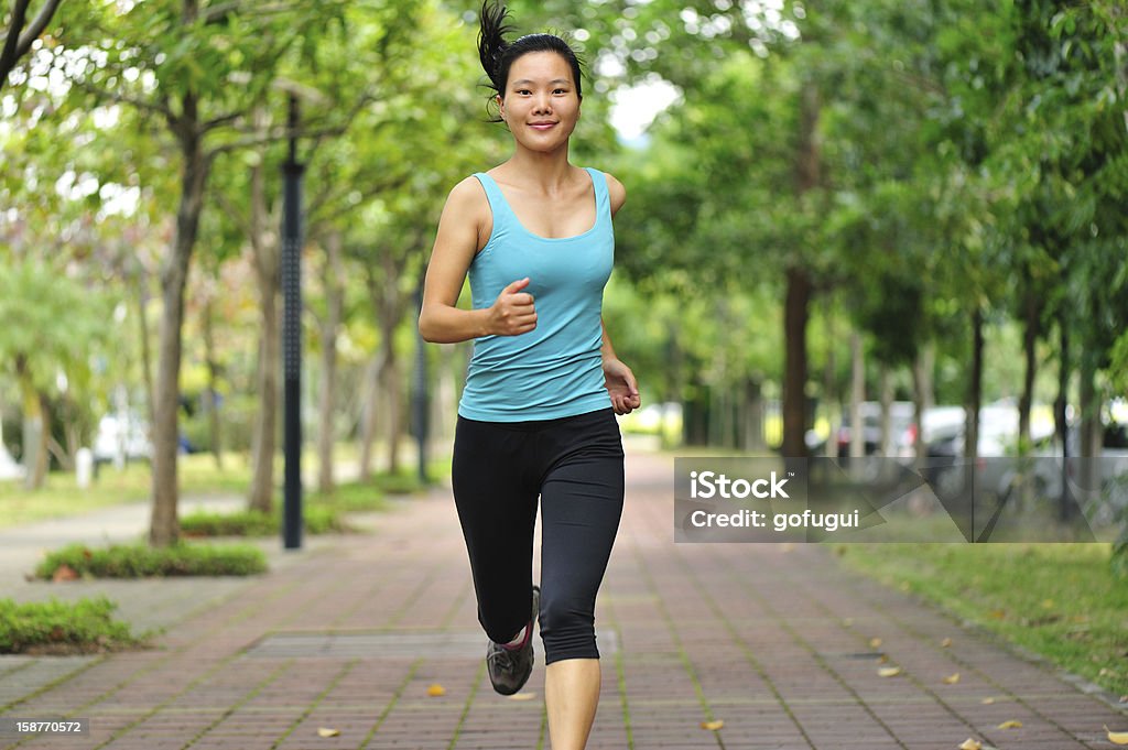 woman runner healthy woman runner runing in gardenPlease see some similar pictures from my portfolio: Asian and Indian Ethnicities Stock Photo