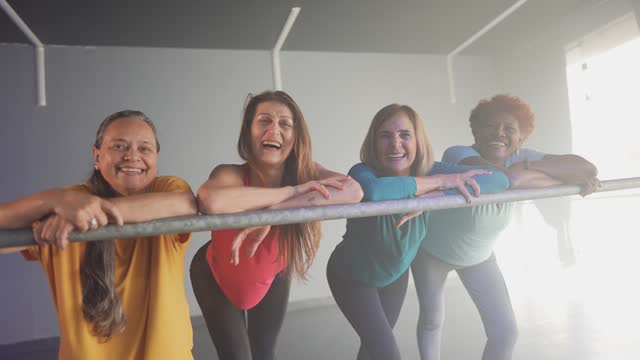 Portrait of senior women stretching at a dance studio