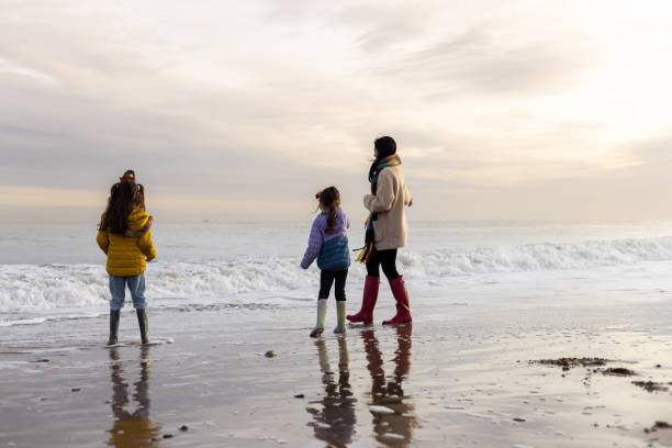 istock Walking Along The Shore with my Children 1587709272