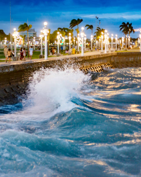 istock Tidal waves along Rizal Boulevard at dusk, Dumaguete waterfront,Negros Island,Philippines. 1587714962