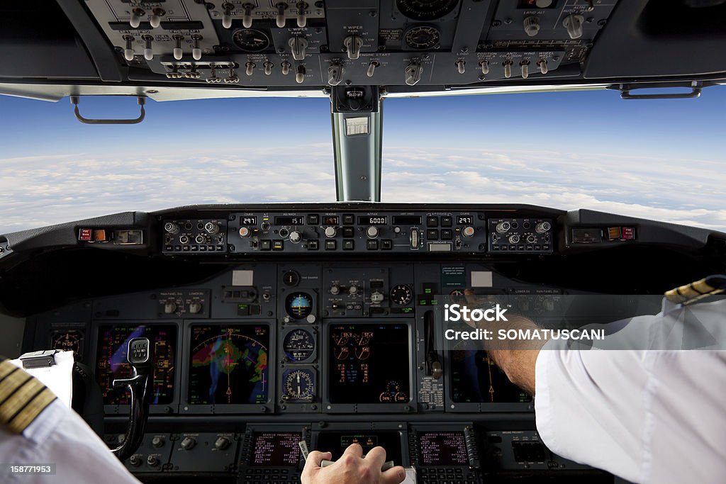 Pilots Working in an Aeroplane During a Commercial Flight Cockpit Stock Photo