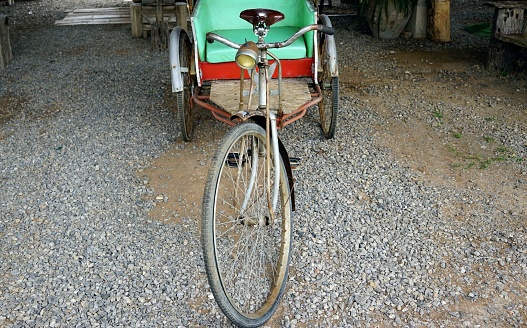 A classic rickshaw parked in the park, vintage classic concept.