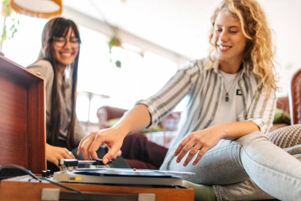 istock Friends listening an old vynil record player 1587744021