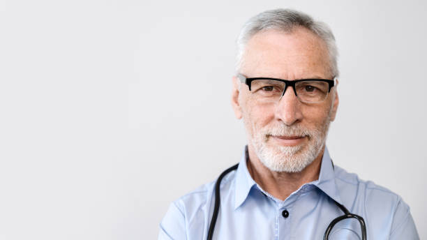 istock middle aged doctor man in glasses on white background 1587753715