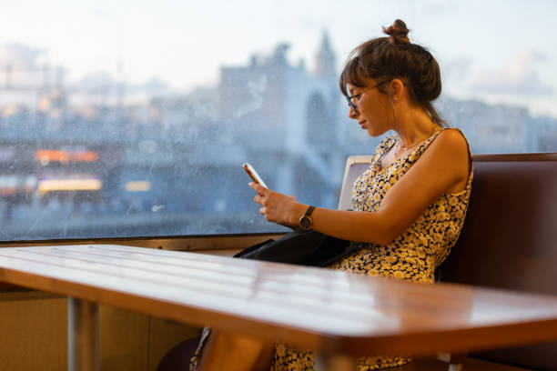 istock Young tourist woman is texting a message on the ferry. 1587794377
