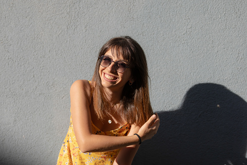 Portrait of pretty young lady on the street.