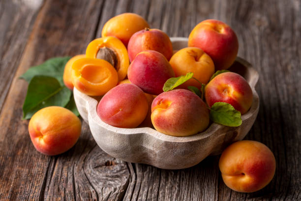 istock Fresh apricot fruit on the wooden background 1587830459