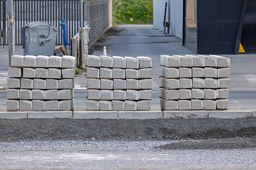 Stacks of Path Kerb Edging Stones Blocks at Street Construction Site