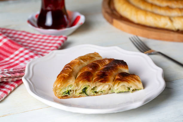 istock Turkish Tepsi Boregi, Round Borek, Tray pastry (Turkish name; rulo borek - ispanakli borek) 1587841487