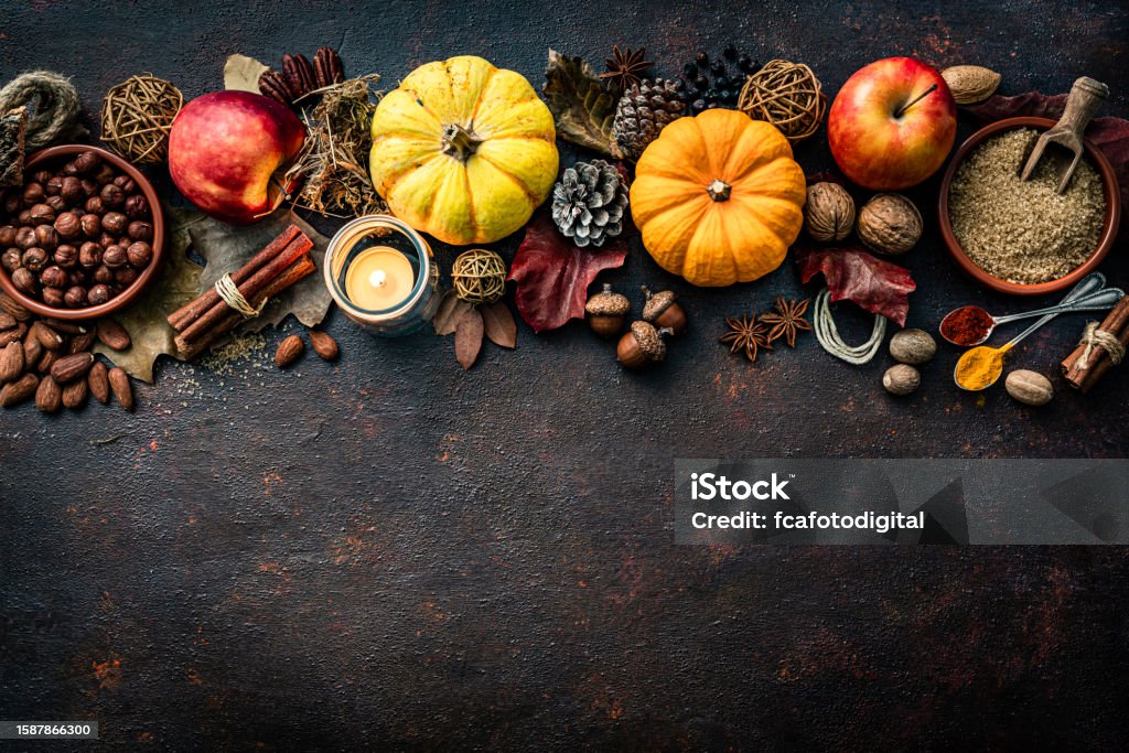 Autumn or Thanksgiving decoration arranged at the top border of a dark table. Copy space Thanksgiving - Holiday Stock Photo