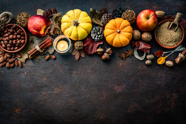 Autumn or Thanksgiving decoration arranged at the top border of a dark table. Copy space stock photo