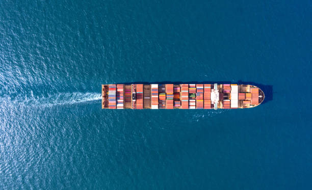istock Top viewContainer ship loading and unloading in sea port, Aerial view of business logistic import and export freight transportation by container ship in harbor, Container loading Cargo freight ship, Dubai 1587897159