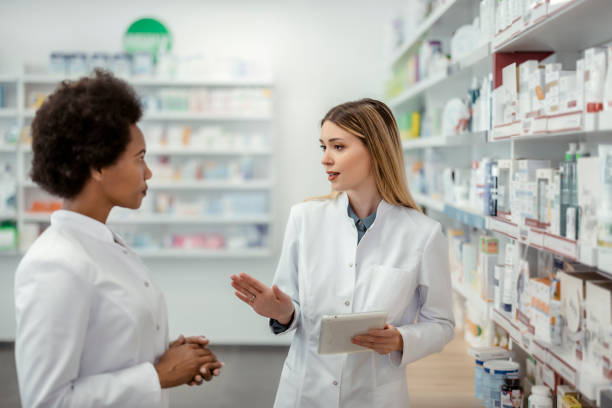 istock Two Mixed Race Female Pharmacists Working at Pharmacy 1587898810