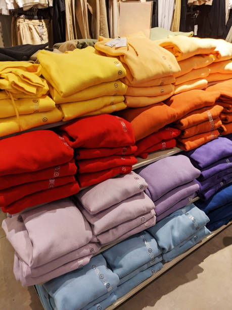 istock Piles of multicolored sweaters on the shelves 1587923483