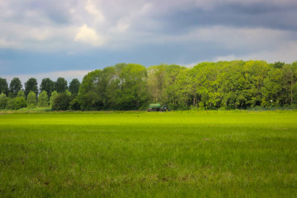 Moody skies over Dutch agricultural field with a tractor in Den Bosch (‘s-Hertogenbosch)