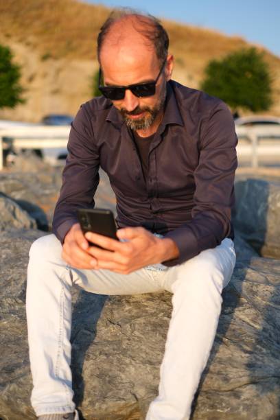 istock Looking at the phone 1587947572