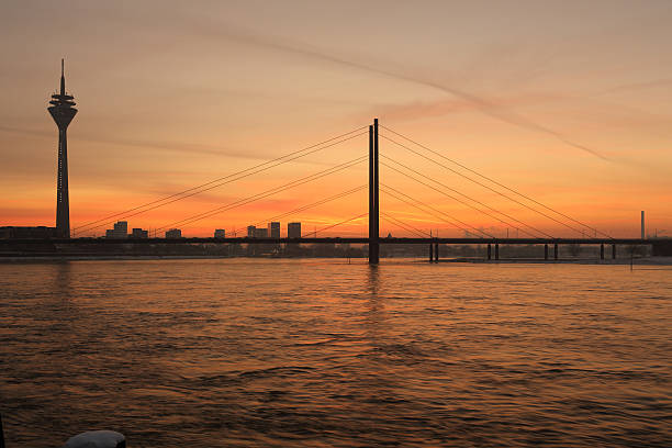 sunset view on Dusseldorf skyline and media harbor with rheinturm and bridge
