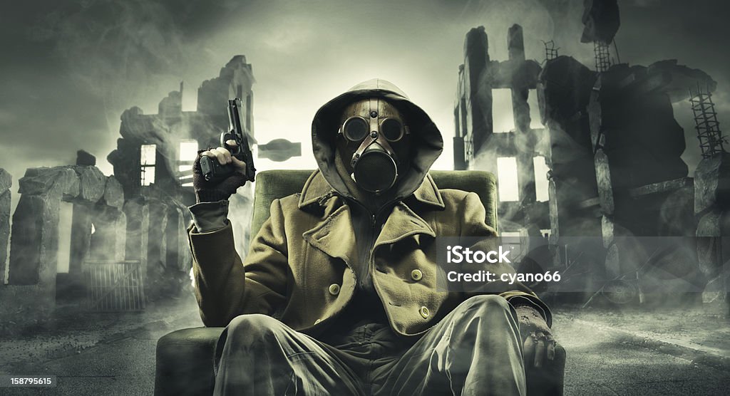 Post apocalyptic survivor in gas mask Post apocalyptic survivor in gas mask, destroyed city in the background Adult Stock Photo