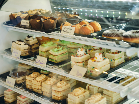 A display case full of pastries in a bakery.