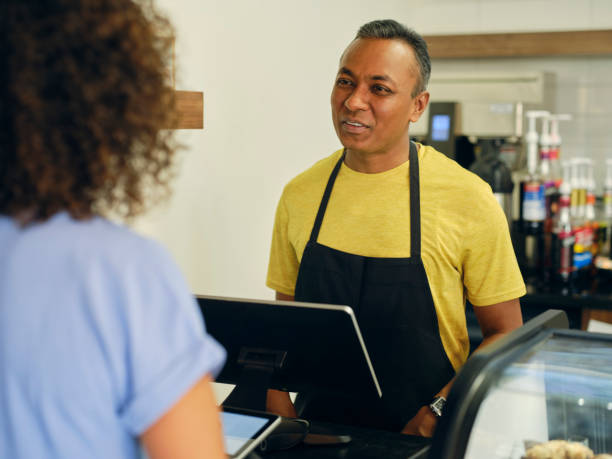 istock Customer and Employee in a Cafe 1587957065
