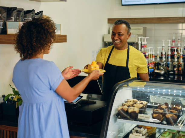 istock Customer and Employee in a Cafe 1587959122