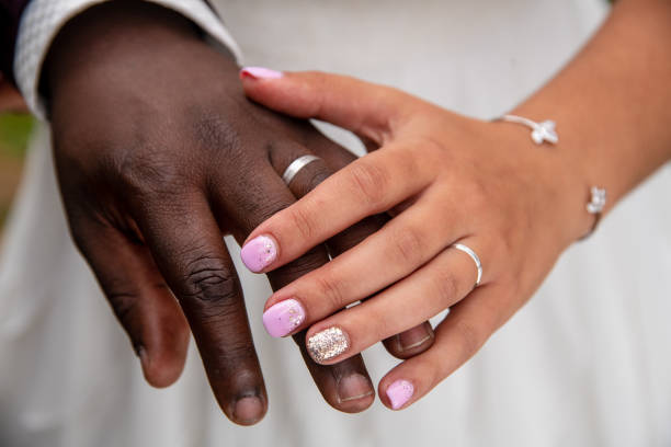 istock Just married black and white couple showing their wedding rings 1587967505