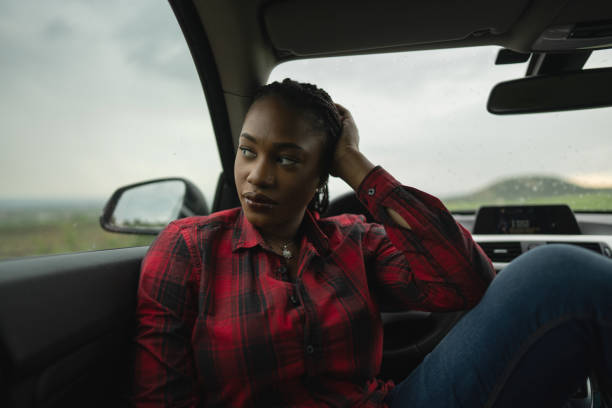 istock Beautiful woman in car 1587973277