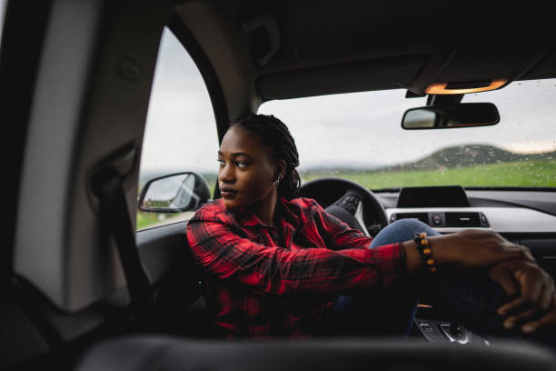 istock Beautiful woman in car 1587973803