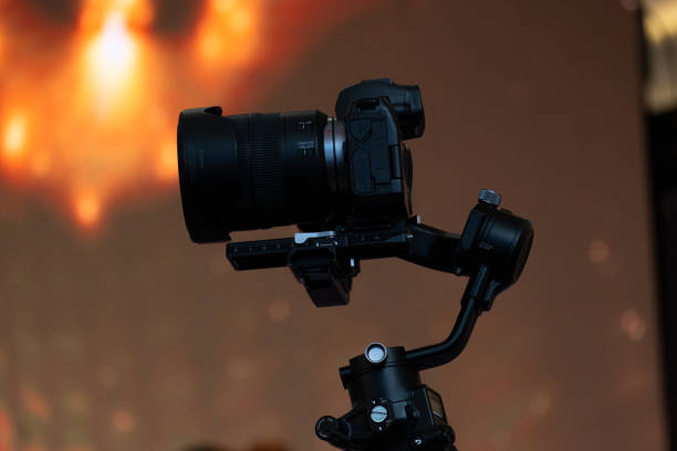 istock The camcorder being mounted with DJI Ronin stabilization accessories to keep things looking good. and has a backdrop of glittering lights to be used as a narrative picture or to study the video 1587983325