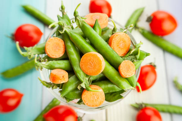 istock green pea carrot on wood 1587992979