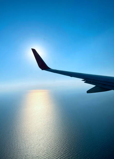 cloud flight sky, cloud airplane sun sky blue air travel wing - window sun sunlight vertical imagens e fotografias de stock