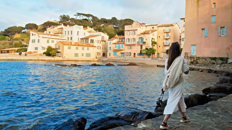 Beautiful girl enjoys the sunset in Cote d'Azur, a coastal town on the French Riviera.