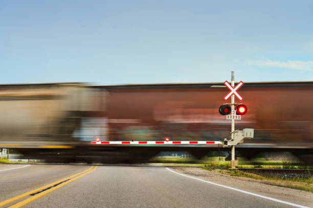 istock Train moving through a railroad crossing in the countryside 1588016085