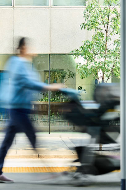 istock Woman pushing a stroller in the city in blurred motion 1588027417