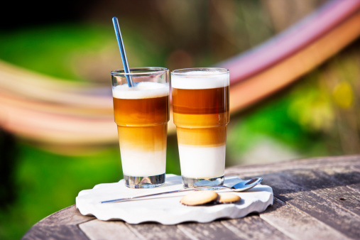 Two Latte Macchiato in a garden. In the back you can see a hammock. XXL size image.