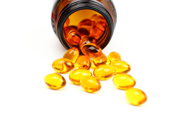 óleo de peixe, ômega-3, lecitina, dha, cápsulas de vitaminas fora da garrafa de vidro marrom com conteúdo derramado isolado no fundo branco. - capsule pill lecithin fish oil - fotografias e filmes do acervo