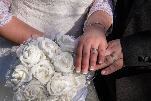 istock Just married showing their rings over the bouquet 1588078108