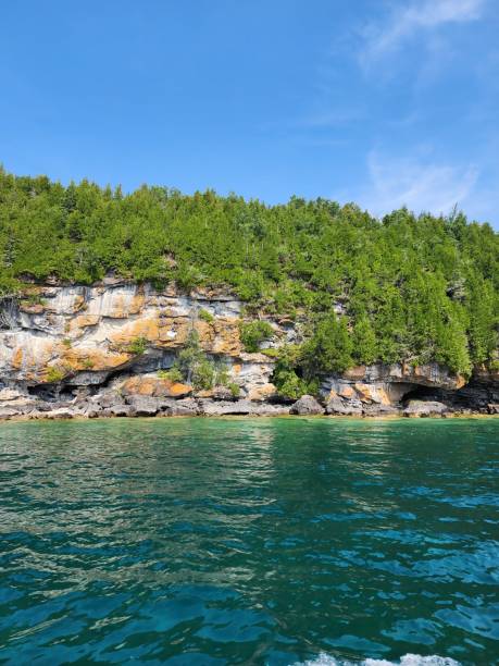 istock Green water and green island under blue sky 1588089699