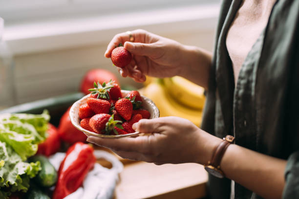 istock An Unrecognizable Woman Eating Strawberries 1588090542