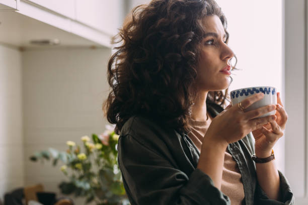 istock A Serious Beautiful Woman Looking Away While Holding A Cup Of Tea 1588090799