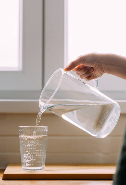 A cropped photo of an unrecognizable Caucasian female keeping herself hydrated.