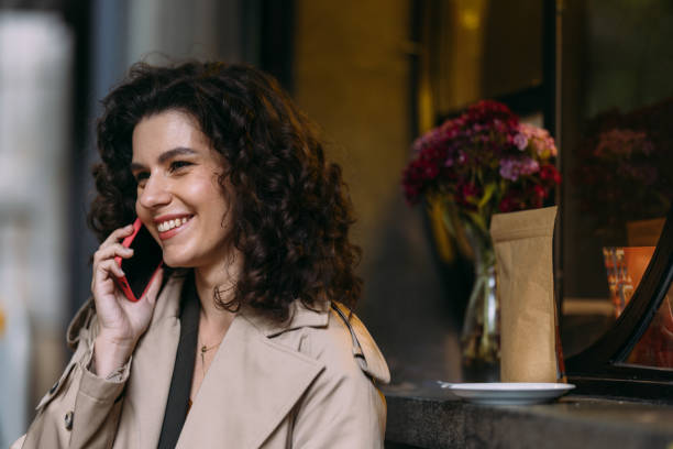istock A Happy Beautiful Businesswoman Using Her Mobile Phone While Looking Away 1588091904