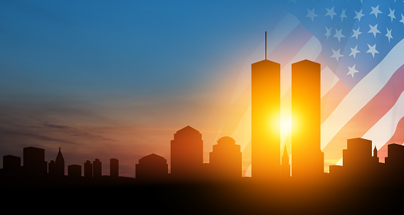 New York skyline silhouette with Twin Towers and USA flag at sunset. 09.11.2001 American Patriot Day banner.