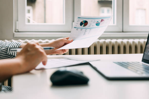 istock Anonymous Female Entrepreneur Analyzing the Company's Financial Records 1588097733
