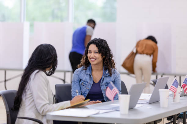 istock Two female volunteers enjoy conversation while taking a break at the voting event 1588098842