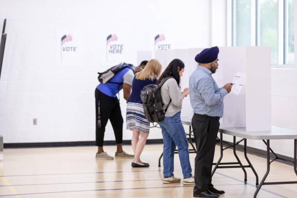 istock Multiracial group of voters participate in early voting 1588098852